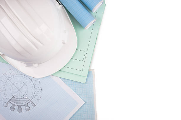 Protective helmet  and rolls of graph paper. stock photo