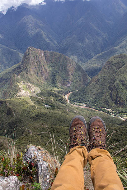 istock Pair of hiking boots and struggled mountains surrounding Machu Picchu 636577110