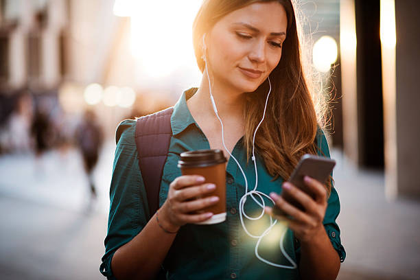 istock Woman using smartphone in the street 636577676