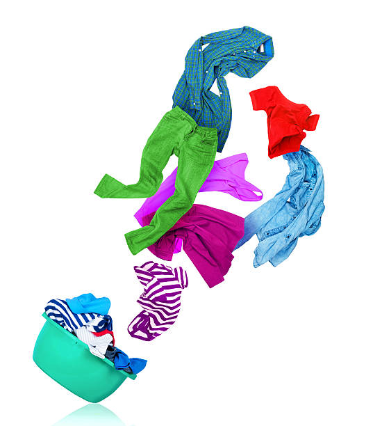 istock bright colorful clothes flying out from wash bowl 636577950