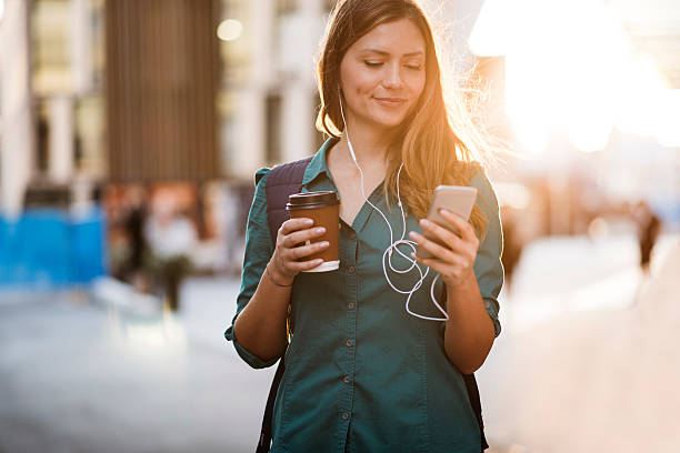 istock Woman using smartphone in the street 636579148