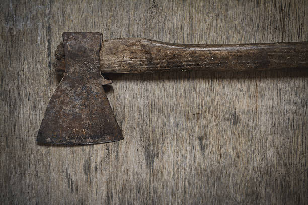 istock old iron ax with wooden handle on plank 636580300