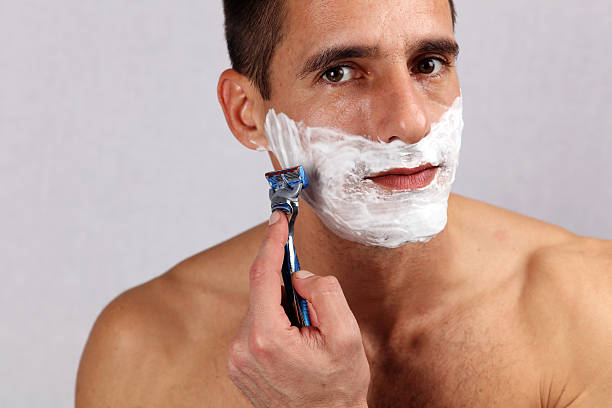 istock Man shaving his face with the razor blade 636581534
