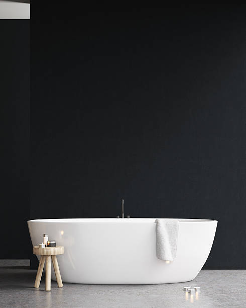 istock Bathtub with a chair and a black wall 636582304