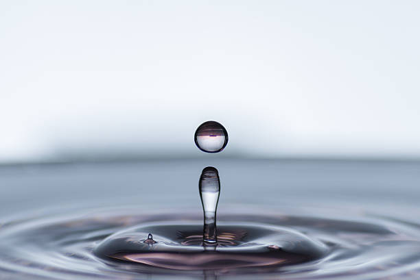 istock Sequence of water droplets making revolution on delicate wet surface 636582458