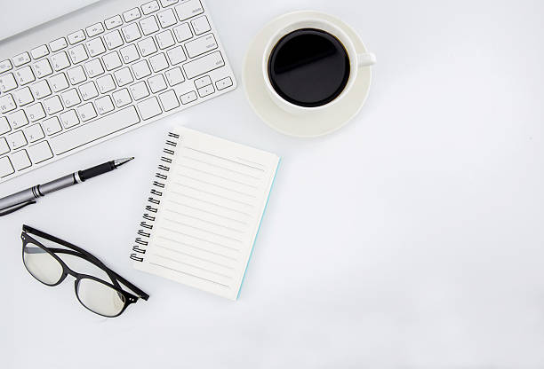 istock office desk with keyboard, notebook, tablet, smartphone and coffee cup 636582566