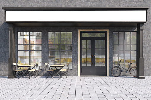 Front view of a cafe exterior with large windows, wooden tables with chairs and a bicycle near the entrance. 3d rendering. Mock up.