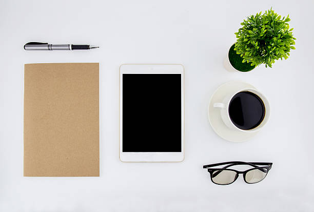 istock office desk with keyboard, notebook, tablet, smartphone and coffee cup 636582934