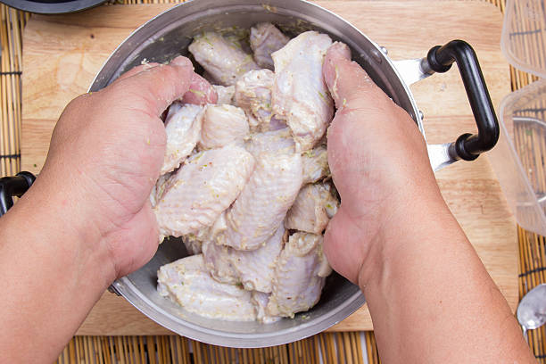 istock Chef mixing flour to chicken wings for cooking 636584616