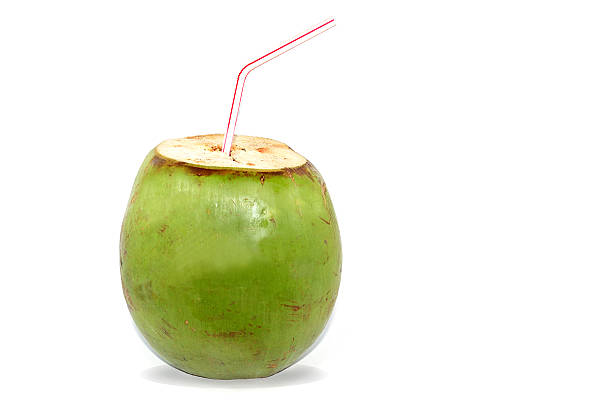 istock Coconut with a white and red straw isolated on white 636588580