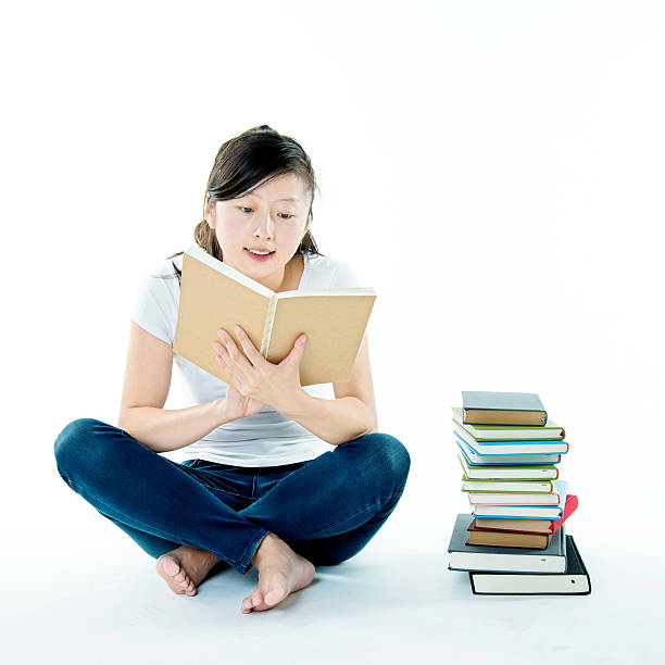 istock Female adult student sitting with books 636592978
