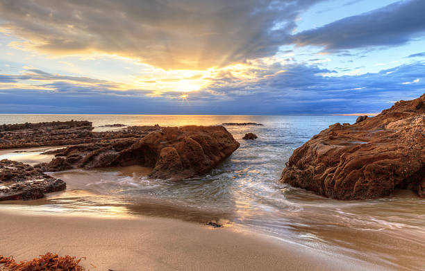 istock Sunset over the rocks at Pearl Street Beach 636594524