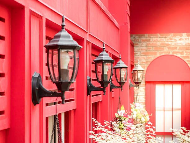 istock vintage style outside lamp hanging on the red wall background 636595366