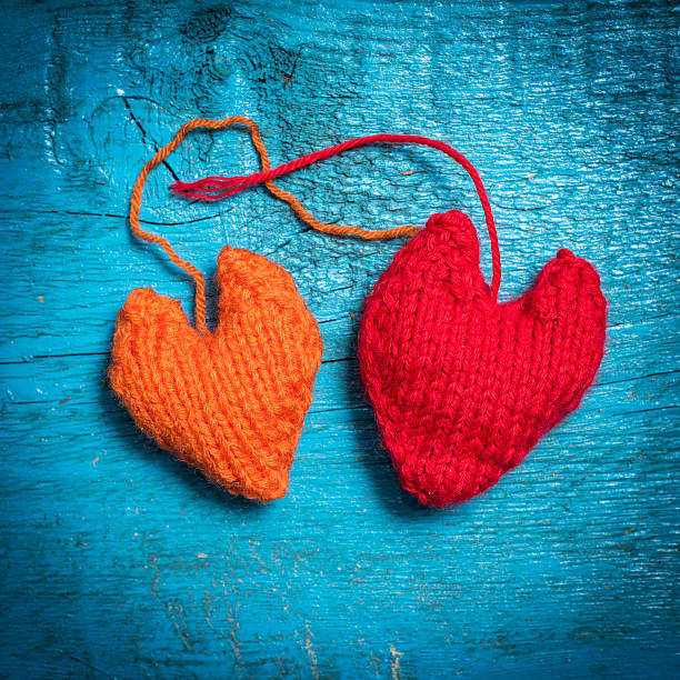 istock Colorful knitted hearts on the blue boards 636597252