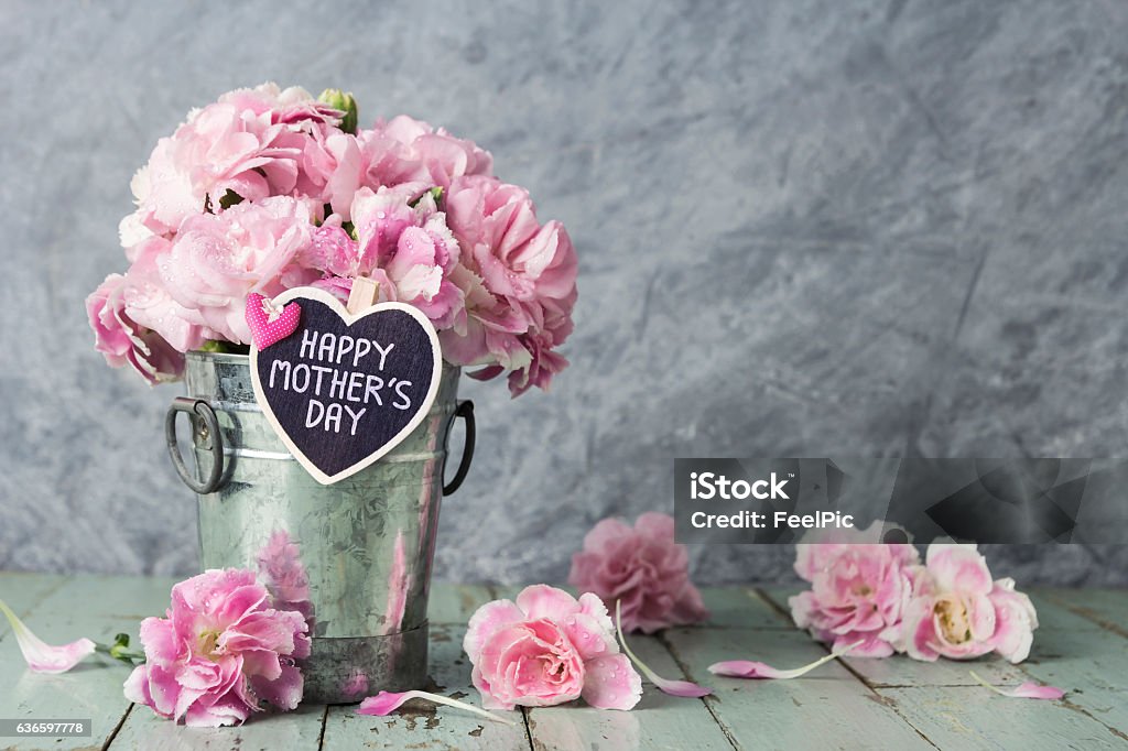 Happy mothers day Pink carnation flowers in zinc bucket with happy mothers day letter on wood heart Mother's Day Stock Photo