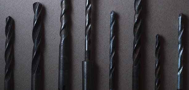 istock set of drill bits on wooden background. 636597942