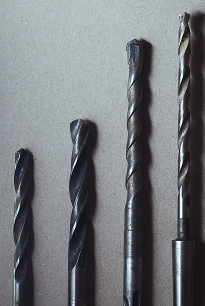 istock set of drill bits on wooden background. 636597988