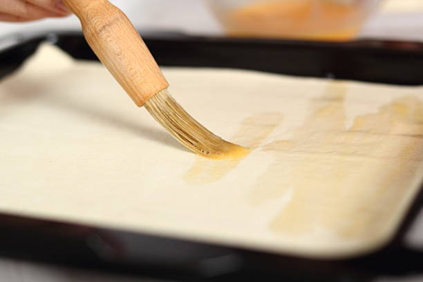 Glaze whole sheet of puff pastry with beaten egg. Making Chicken and Egg Galette Series.