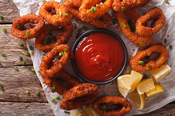 istock Squid rings fried in breadcrumbs closeup on a table. horizontal 636600206