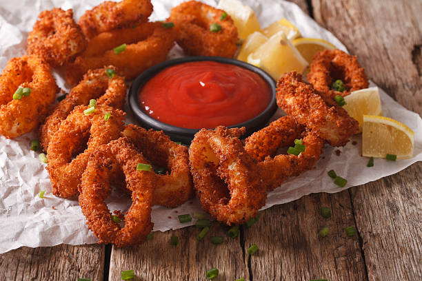 istock squid rings in breadcrumbs and tomato sauce closeup. horizontal 636600396