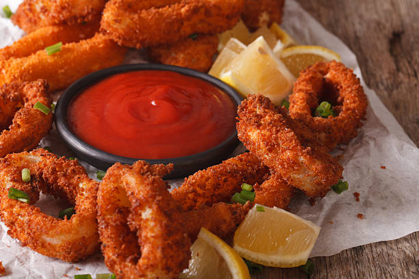 istock fried calamari rings with ketchup and lemon on the table 636600566