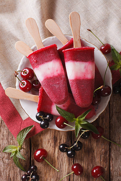 istock Fruit ice cream with cherry and currants on a stick 636602518