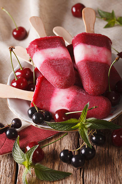 istock Tasty berry ice cream with mint closeup on stick. vertical 636602674