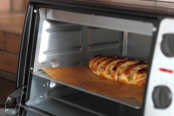 istock Removing freshly baked pie from oven 636605168