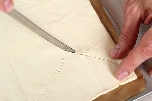 istock Cutting Fish Shape from Sheet of Puff Pastry 636608888