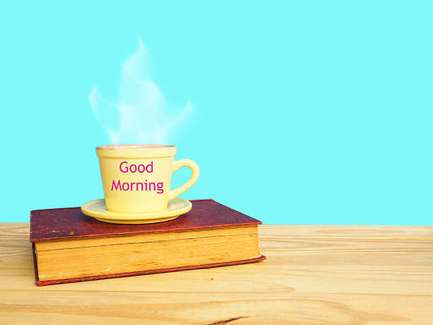 istock Good morning wording on coffee cup and old book 636611618