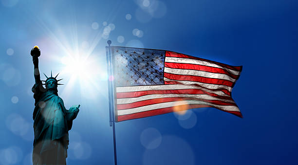 istock statue of liberty and american flag 636613920