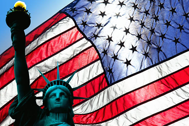 istock statue of liberty and american flag 636613974