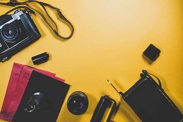 istock Old camera and equipment on a yellow background 636614022