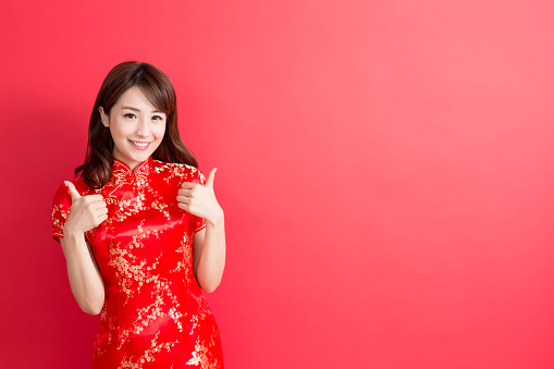 beauty woman wear cheongsam and thumb up with chinese new year