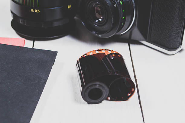 istock Old camera and equipment on a light wooden background 636614298
