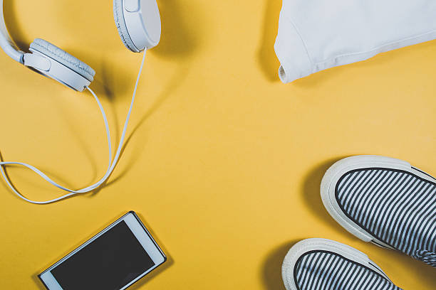 istock Gadgets and summer clothes on yellow background 636614524