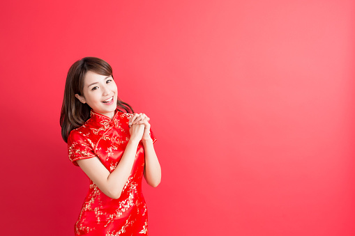 beauty woman wear cheongsam and show something to you in chinese new year