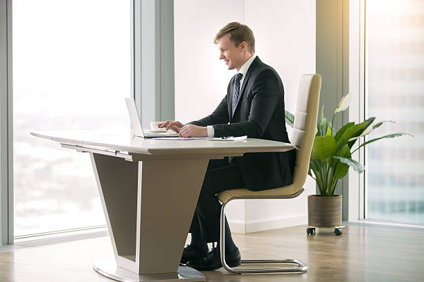 istock Businessman working with laptop at the moderm desk 636614622