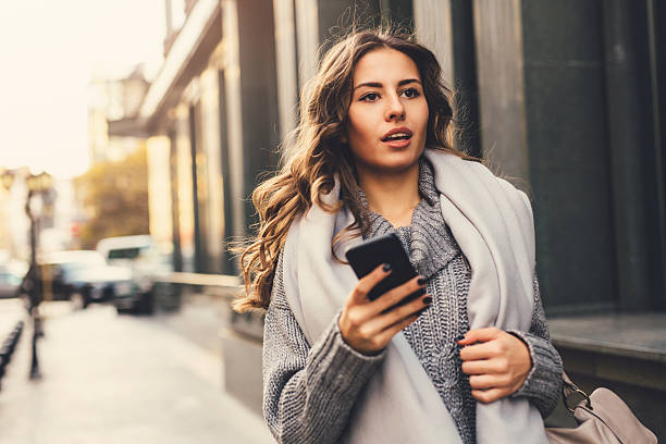 istock Woman texting outdoors 636614664