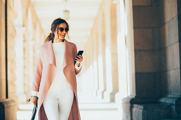 istock Beautiful elegant woman texting outdoors 636615036
