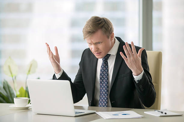 puzzled businessman in office - frustration computer confusion businessman imagens e fotografias de stock