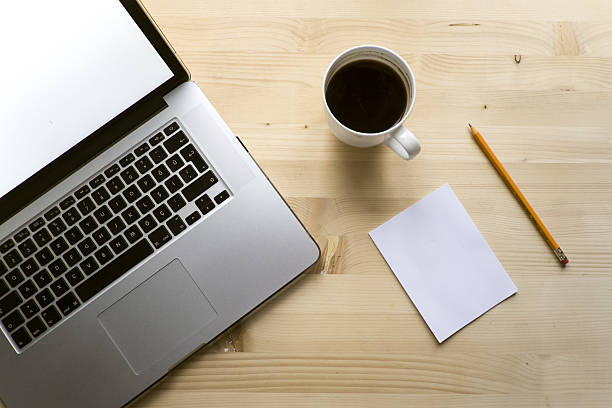 istock Laptop and Notepaper and Pencil on wooden table 636617684