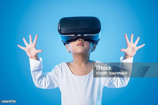 Asian Chinese Little Girl Experiencing Virtual Reality Eyeglasss Stock Photo - Download Image Now