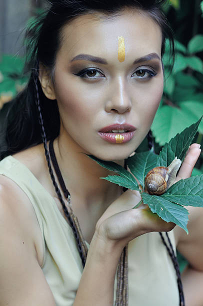 istock Beautiful girl holding a snail in hands 636622002