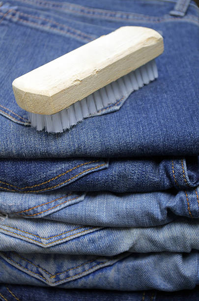 wooden brush with blue jeans stock photo