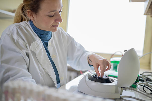 istock Inserting test tube in microcentrifuge 636622854
