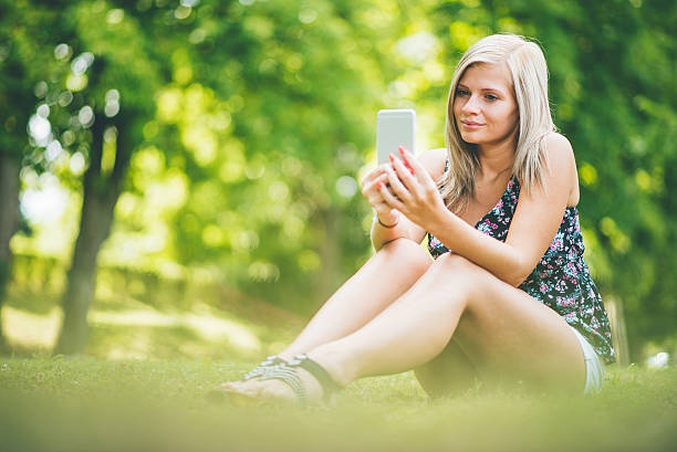 istock young woman with smart phone in summer 636623246