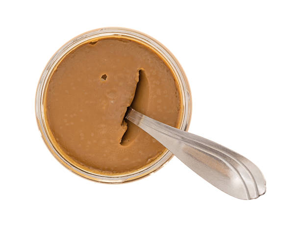 istock Cookie butter in an opened jar with a spoon 636623308