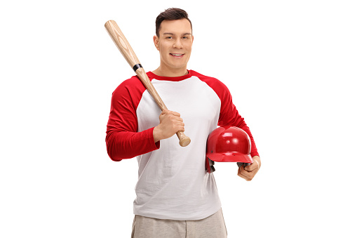 Happy baseball player holding a bat and a helmet isolated on white background
