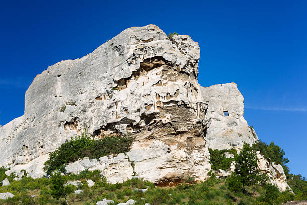 The massive rock of Les Baux de Provence (France) on a clear morning in springtime with blue sky